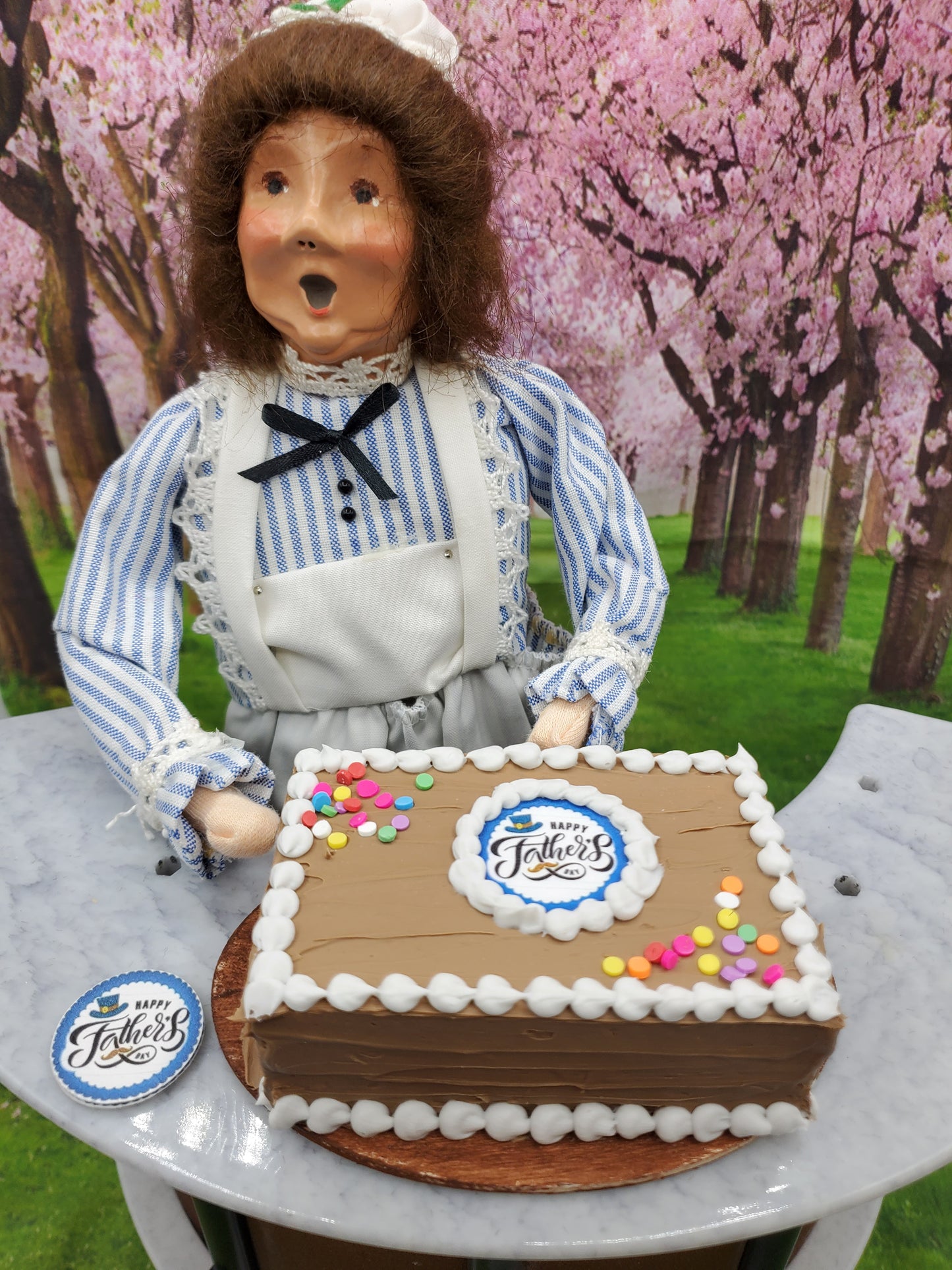 Chef Gina's® Mini Food doll with 1:4 scale Father's Day chocolate cake decorated with colorful sprinkles