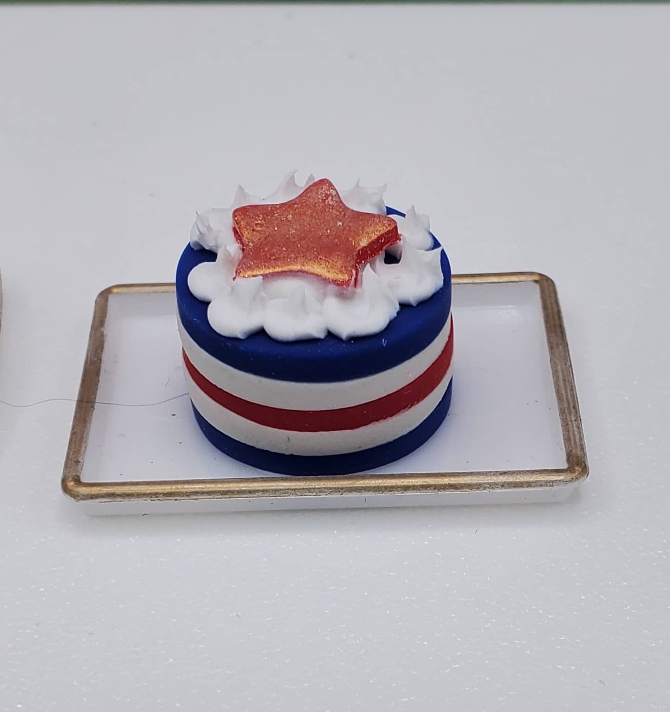 Small cake with red, white, and blue colors on a white background