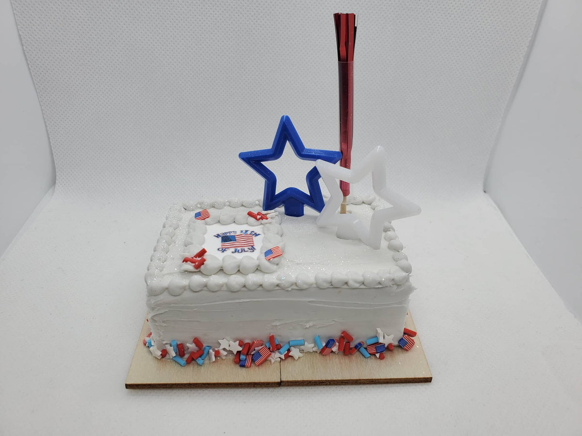 4th of July doll cake for 1:4th scale dolls with festive decorations and a star-shaped candle