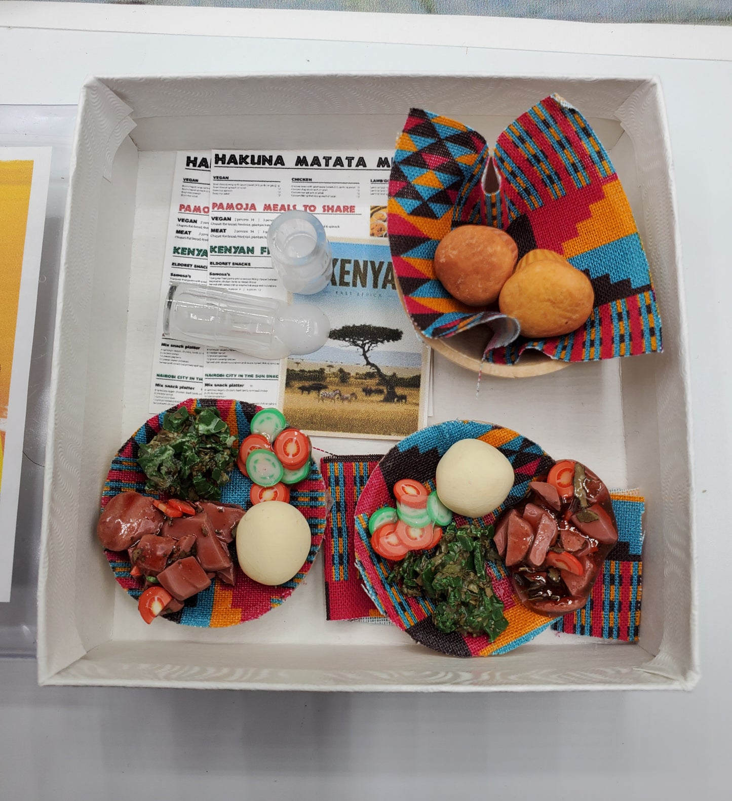 African Kenya mini food set by Chef Gina's featuring traditional dishes on colorful fabric plates