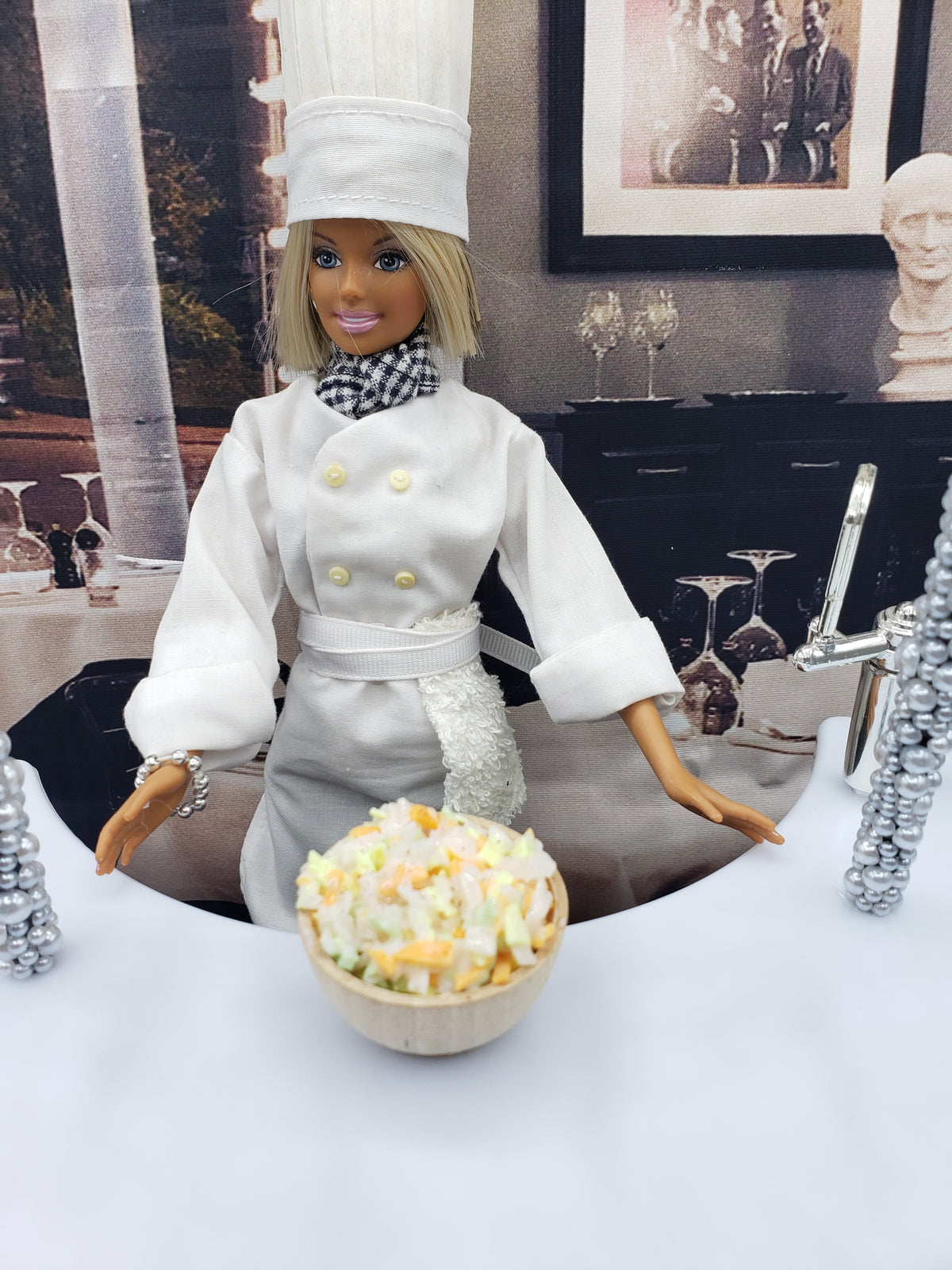 Chef doll presenting a bowl of miniature coleslaw for dolls in a stylish kitchen setting