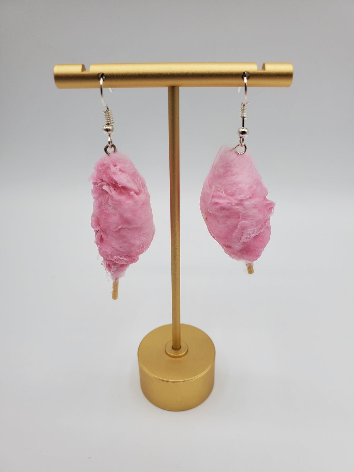 Chef Gina's Mini Food pink cotton candy earrings hanging on gold display stand
