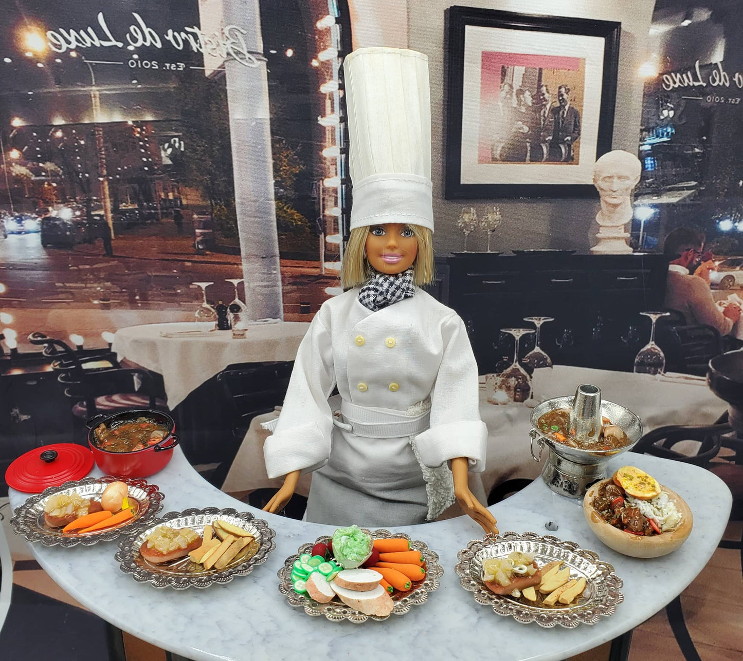 Chef doll in white uniform with handmade doll stew pot and miniature food accessories on table