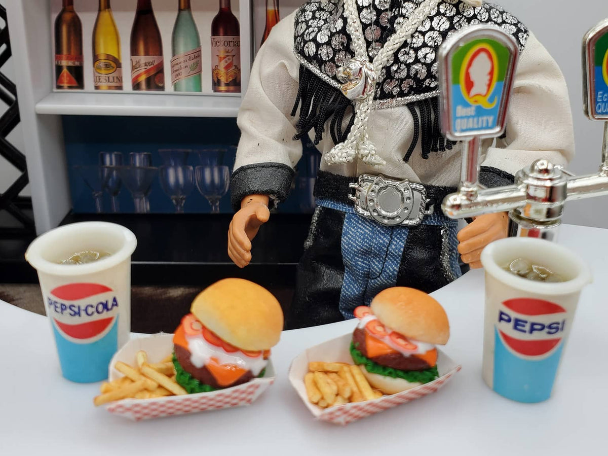 Miniature bison burgers for dolls with fries and Pepsi cups in a doll cowboy bar setting