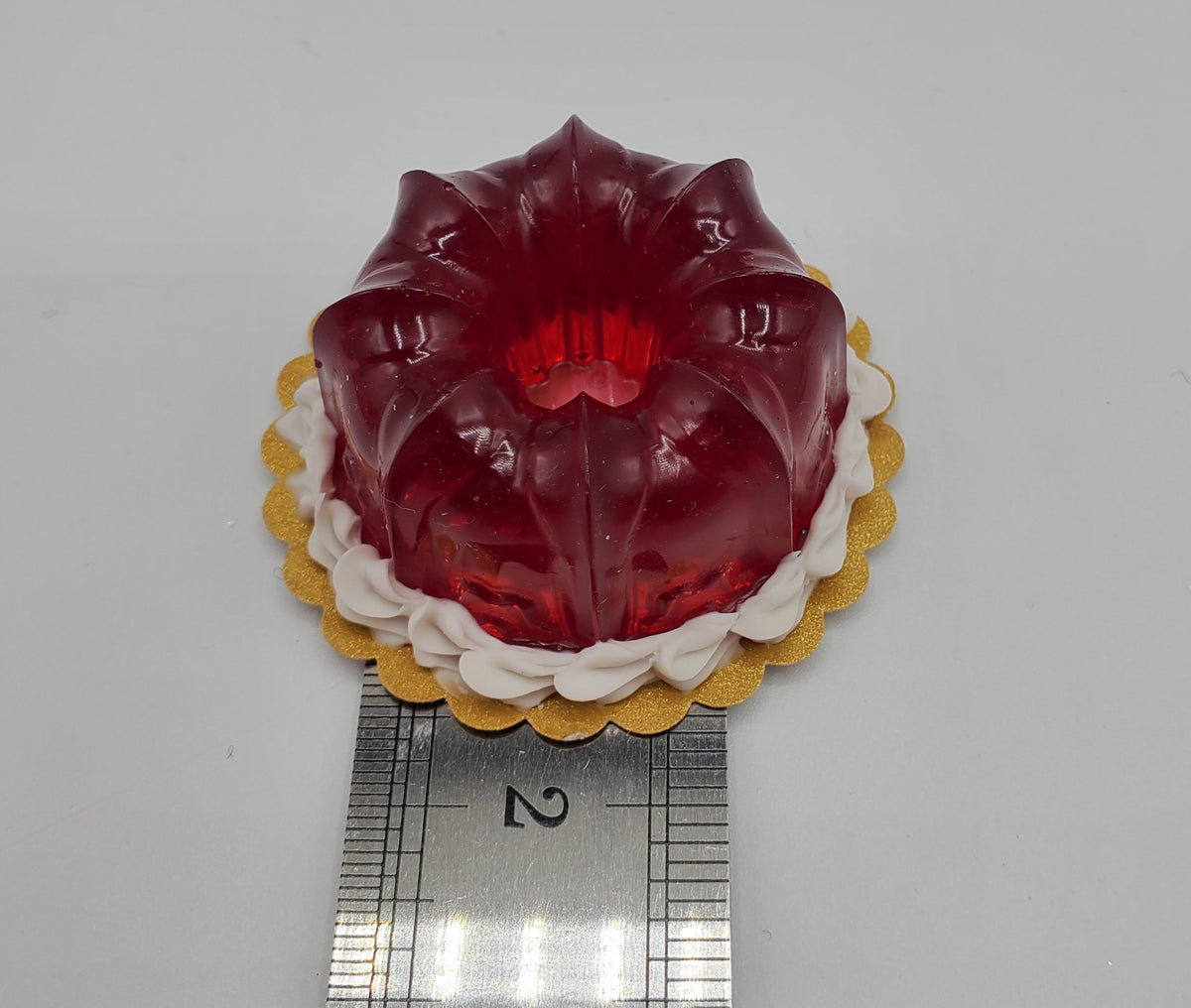 Chef Ginas miniature cranberry jello dessert shaped like a small red gelatin mold on a gold base
