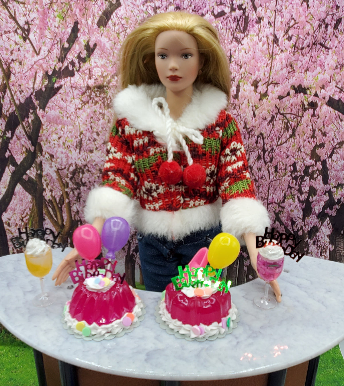 Miniature happy birthday cocktail drinks with colorful balloons and cakes on a table with doll figure background