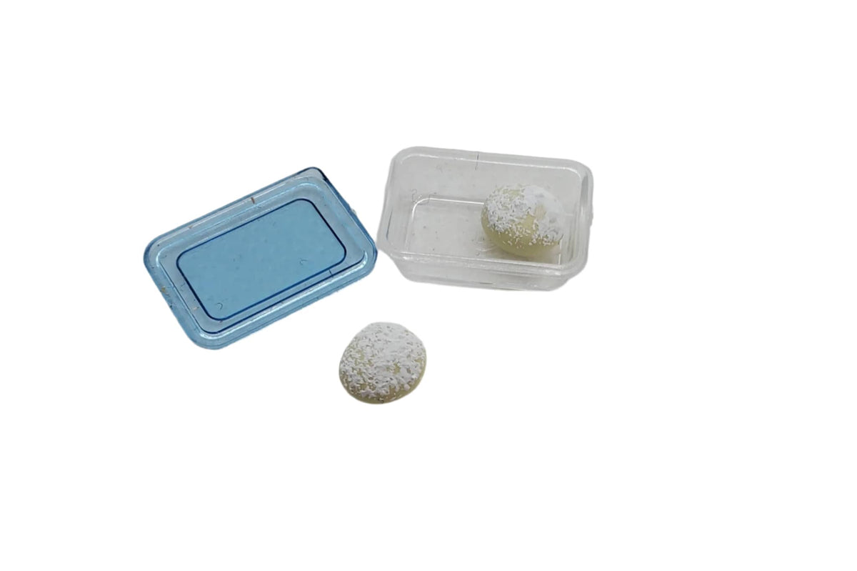 Chef Gina's® miniature rum balls for dolls in clear packaging with decorative snow topping