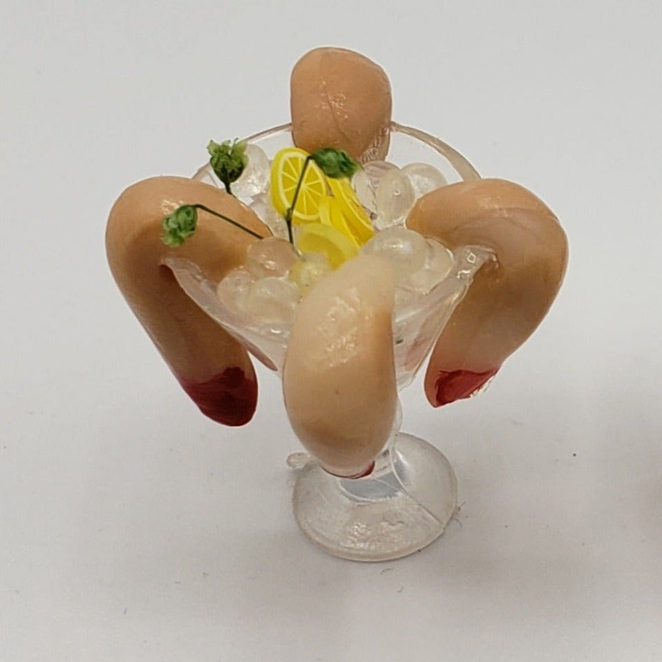 Chef Gina's miniature shrimp cocktail with three shrimp, lemon slices, and garnish in a glass