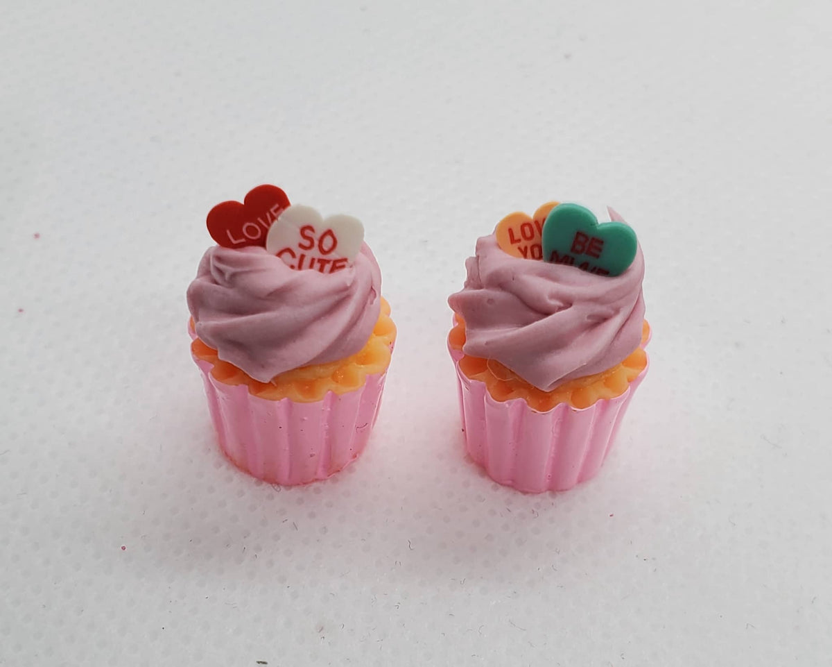 Chef Ginas miniature Valentine's cupcakes with pink frosting and heart-shaped candy toppers