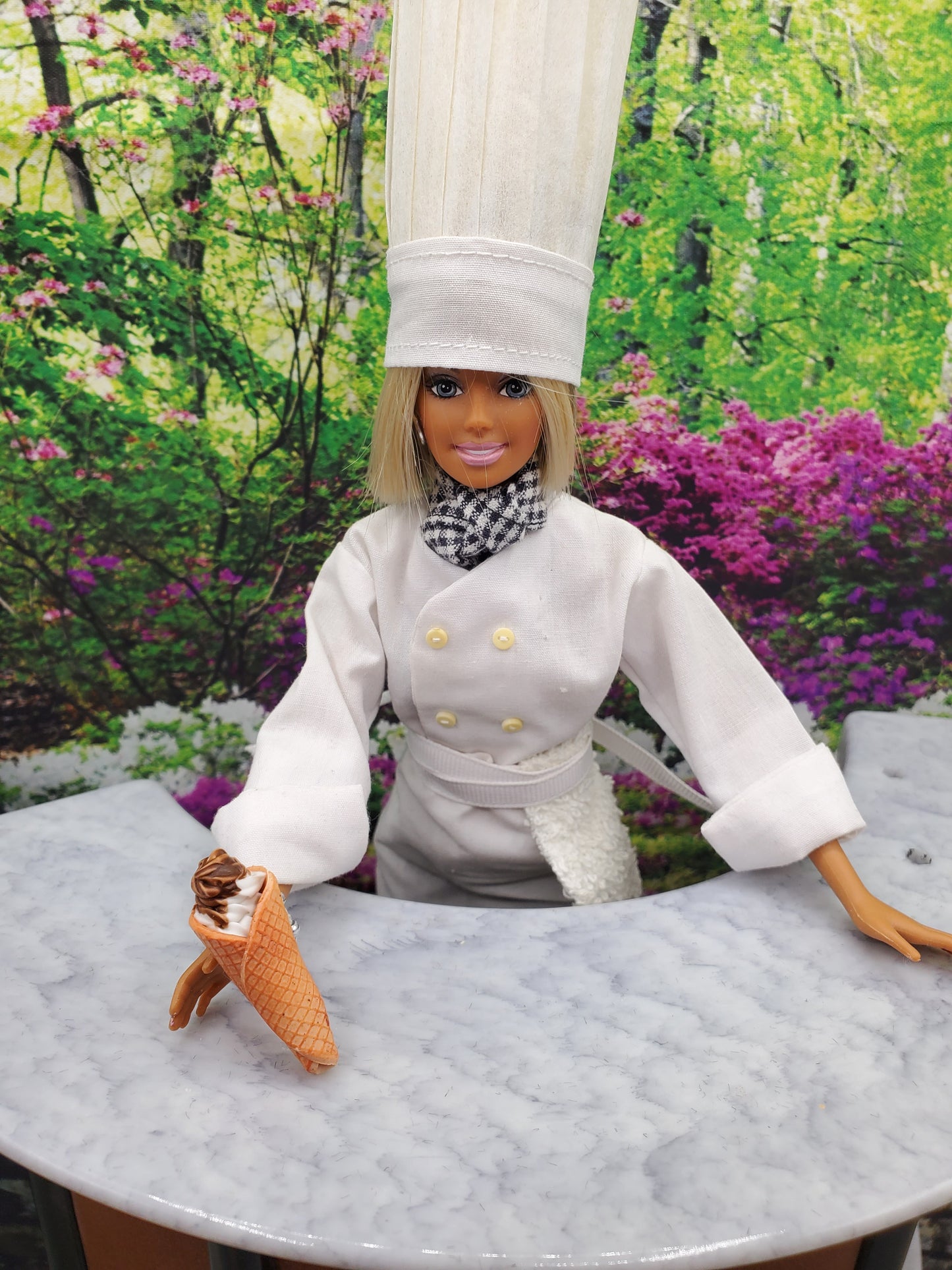 Chef Gina's Mini Food doll holding miniature waffle cone ice creams with chocolate topping