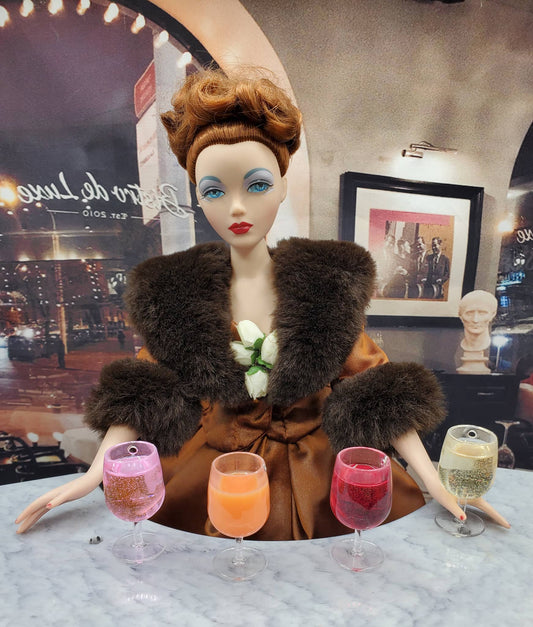 Chef Gina's miniature white wine for 1 4th scale displayed with a doll in vintage attire holding four different wine glasses