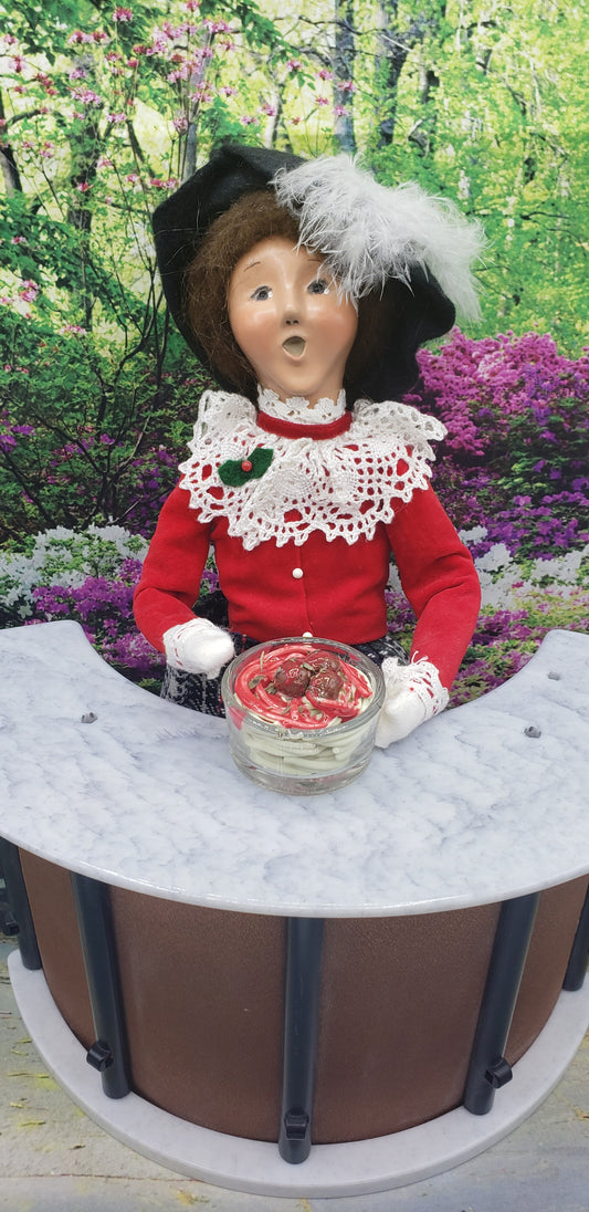 1:4th scale Spaghetti and Meatballs for dolls displayed in front of a doll dressed in vintage red and white outfit with black hat