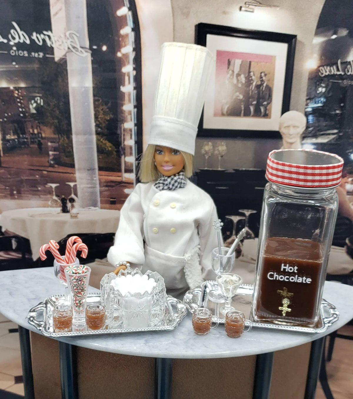 Mini hot chocolate bar for dolls with chef figure, candy canes, and hot chocolate display