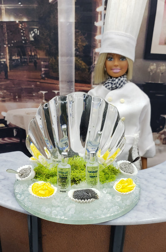 Miniature ice carving sculpture with decorative shell, caviar, and vodka bottles for hors d'oeuvres presentation