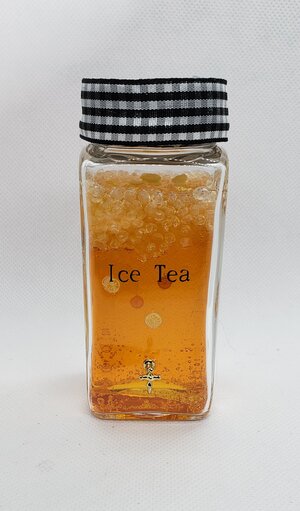 Miniature ice tea dispenser filled with refreshing iced tea, perfect for summer gatherings