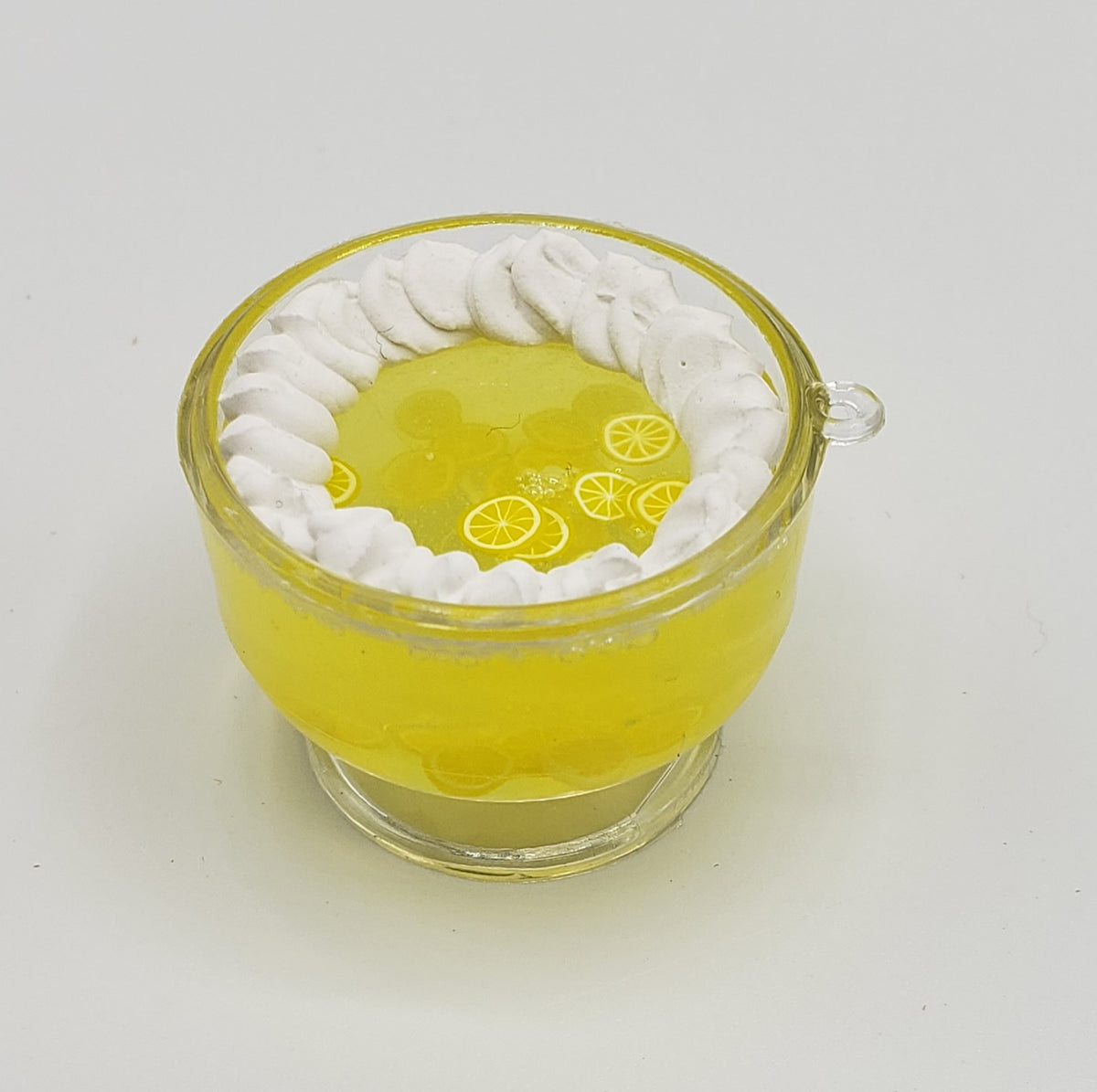 Miniature jello trifle topped with whipped cream and lemon slices in a clear cup