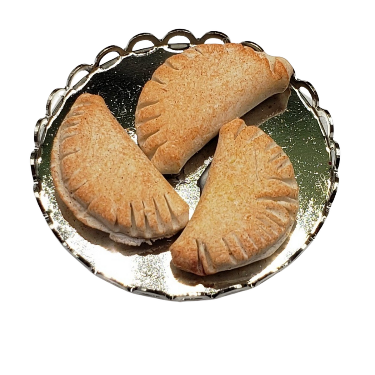 Platter with three miniature pierogi for dolls featuring golden-brown crusts and delicious filling