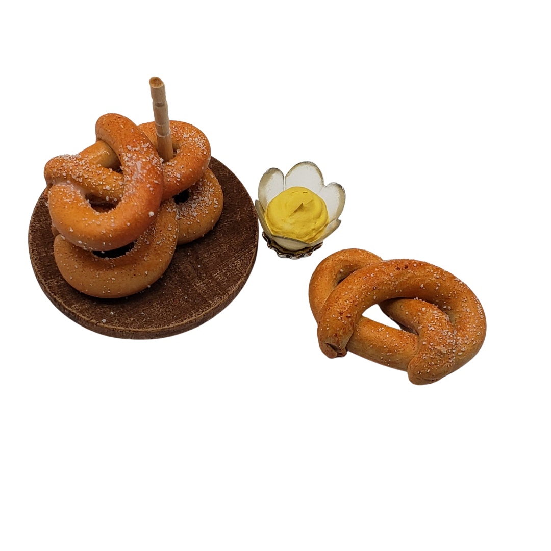Chef Gina's® Mini Food miniature pretzel tower with three pretzels and a dipping cup of mustard