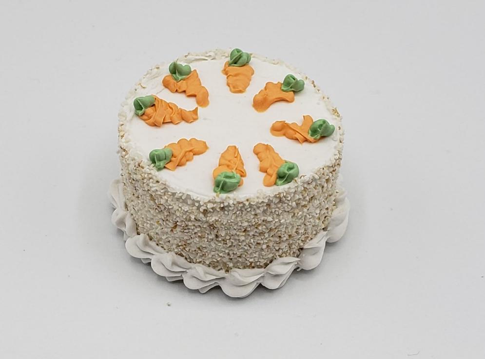 Realistic doll food carrot cake with decorative frosting and carrot accents on top