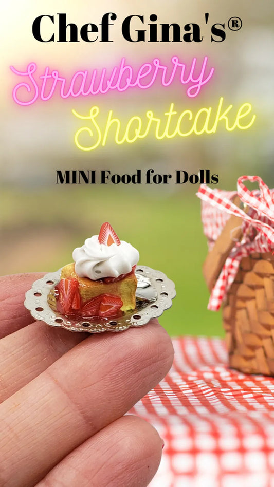 Strawberry shortcake held by fingers showcasing 1:6 scale miniature food craftsmanship by Chef Gina's®