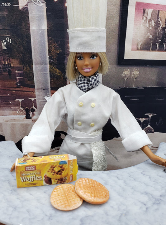 Chef doll with box of 1:6 scale dollhouse waffles on a marble counter in a restaurant setting