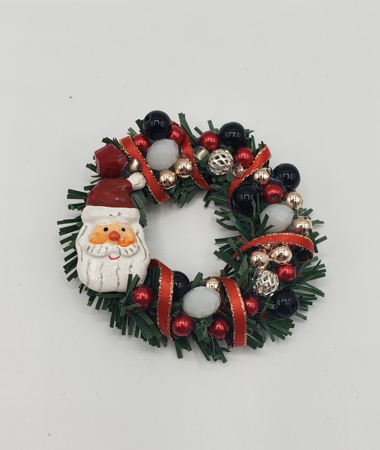 santa Wreath with red, white , black, silver and gold beads