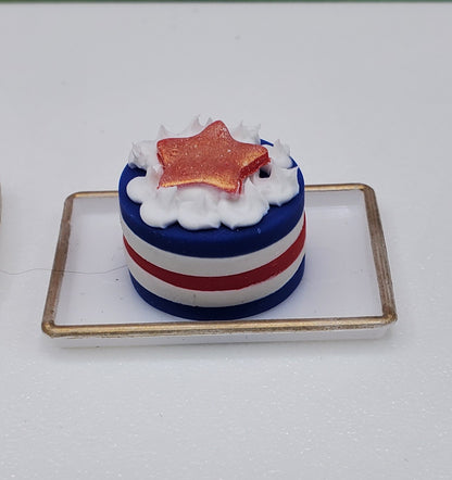 Small cake with red, white, and blue colors on a white background