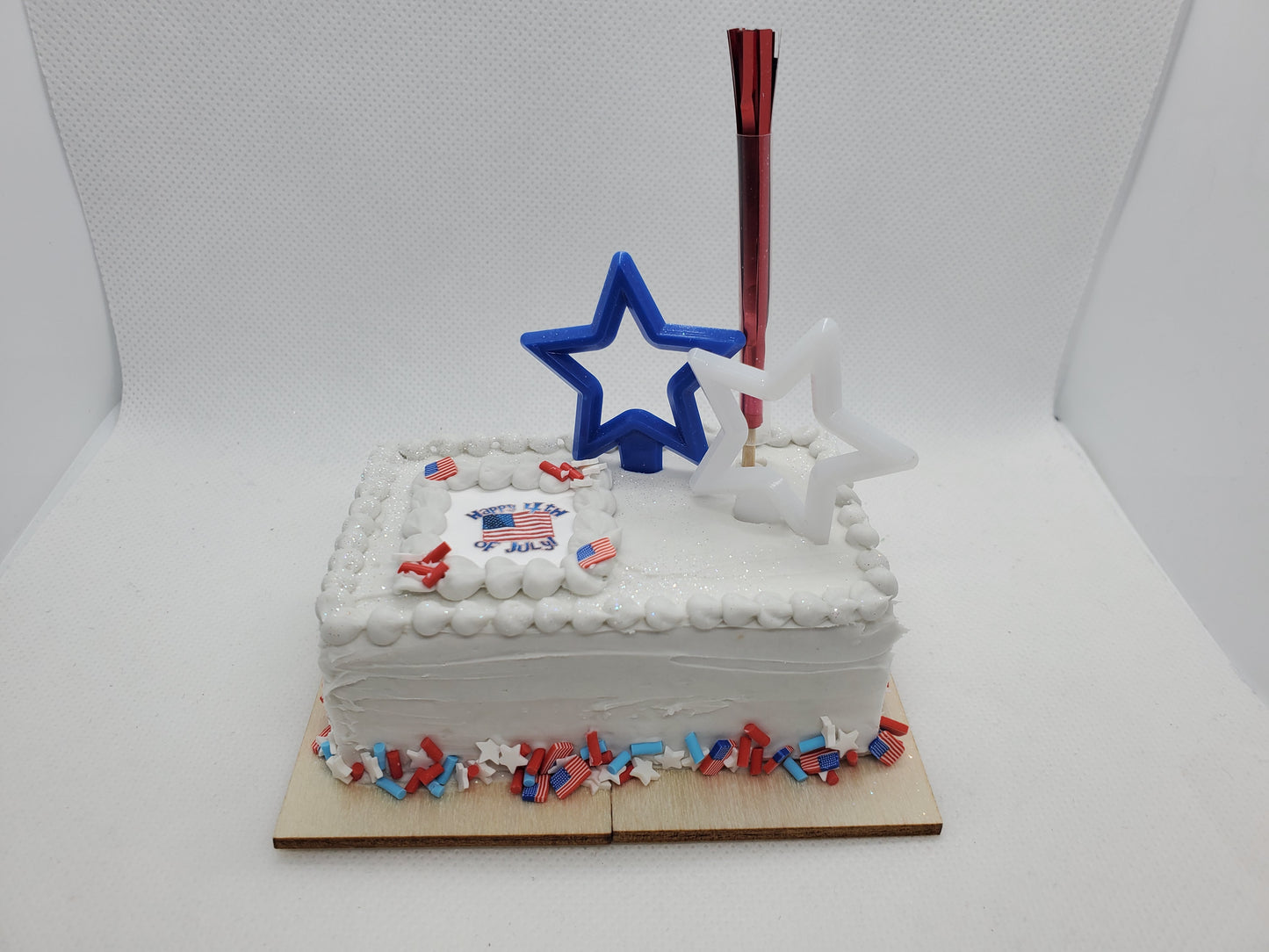 4th of July doll cake for 1:4th scale dolls with festive decorations and a star-shaped candle