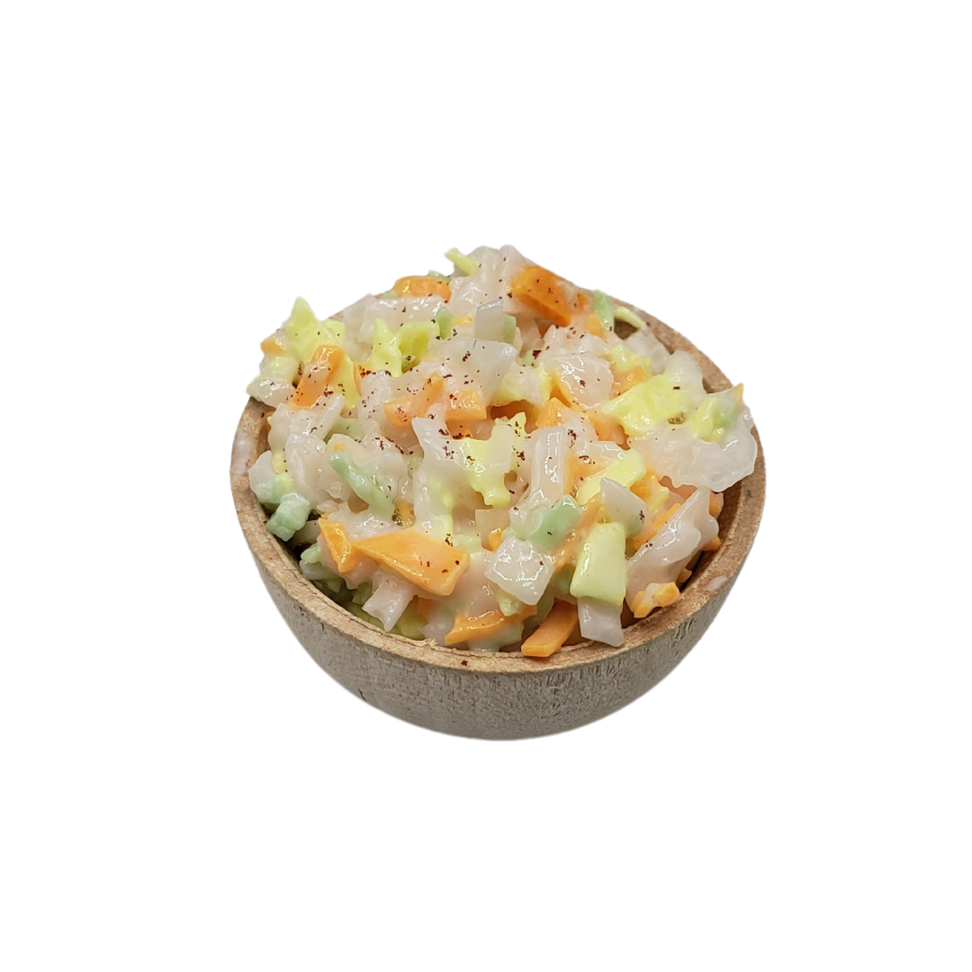 Miniature coleslaw for dolls in a brown wooden bowl, featuring diced vegetables