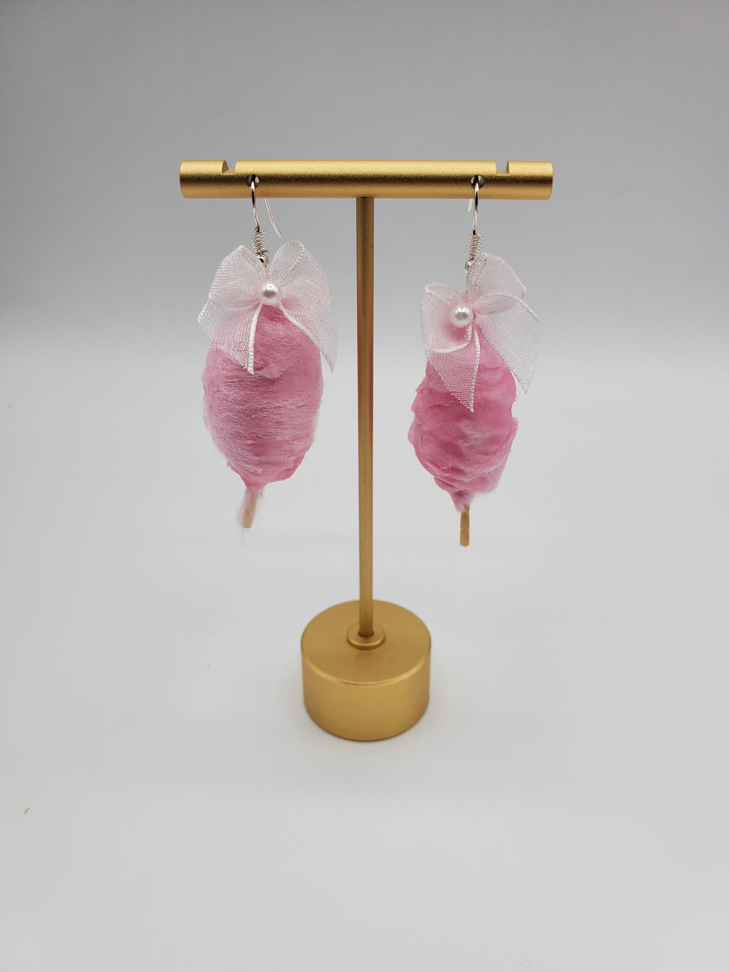 Chef Gina's Mini Food pink cotton candy earrings with delicate white bows on gold display stand