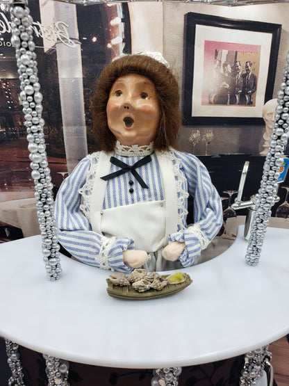 Chef Gina's doll sized conk appetizers displayed with a doll in vintage maid outfit at a miniature table