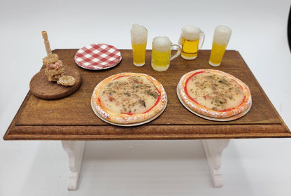 Chef Gina's mini food dollhouse beer and pizza party set with pizzas, beer mugs, plate, and skewers on wooden table