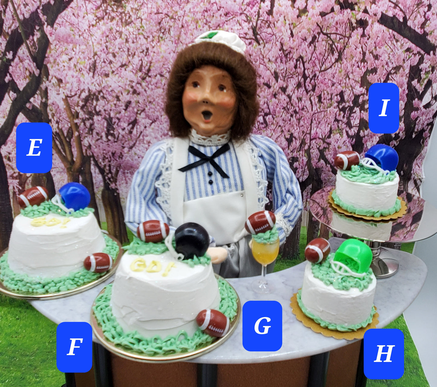 Chef Gina's Mini Food cakes decorated with football party doll accessories including helmets and footballs on white frosting