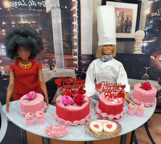 Chef Gina's mini Linzer cookies dolls display with two dolls and pink Valentine themed desserts on a table