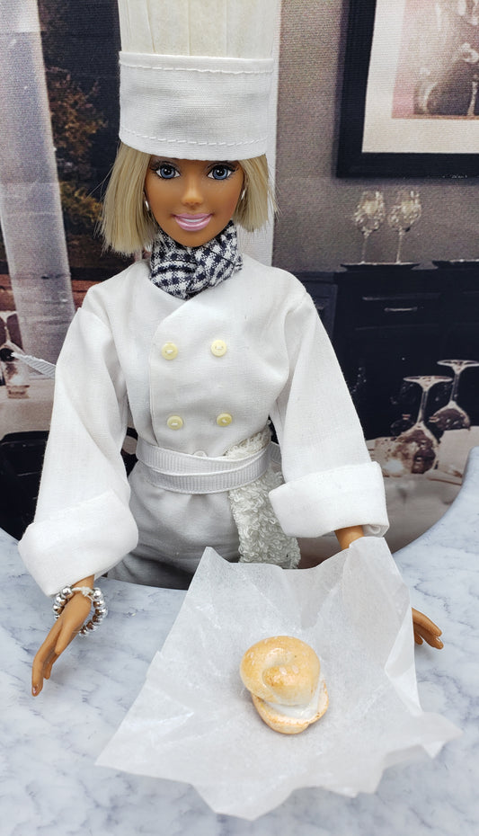 Chef Gina's Mini Food miniature bagel with cream cheese held by doll chef in white uniform