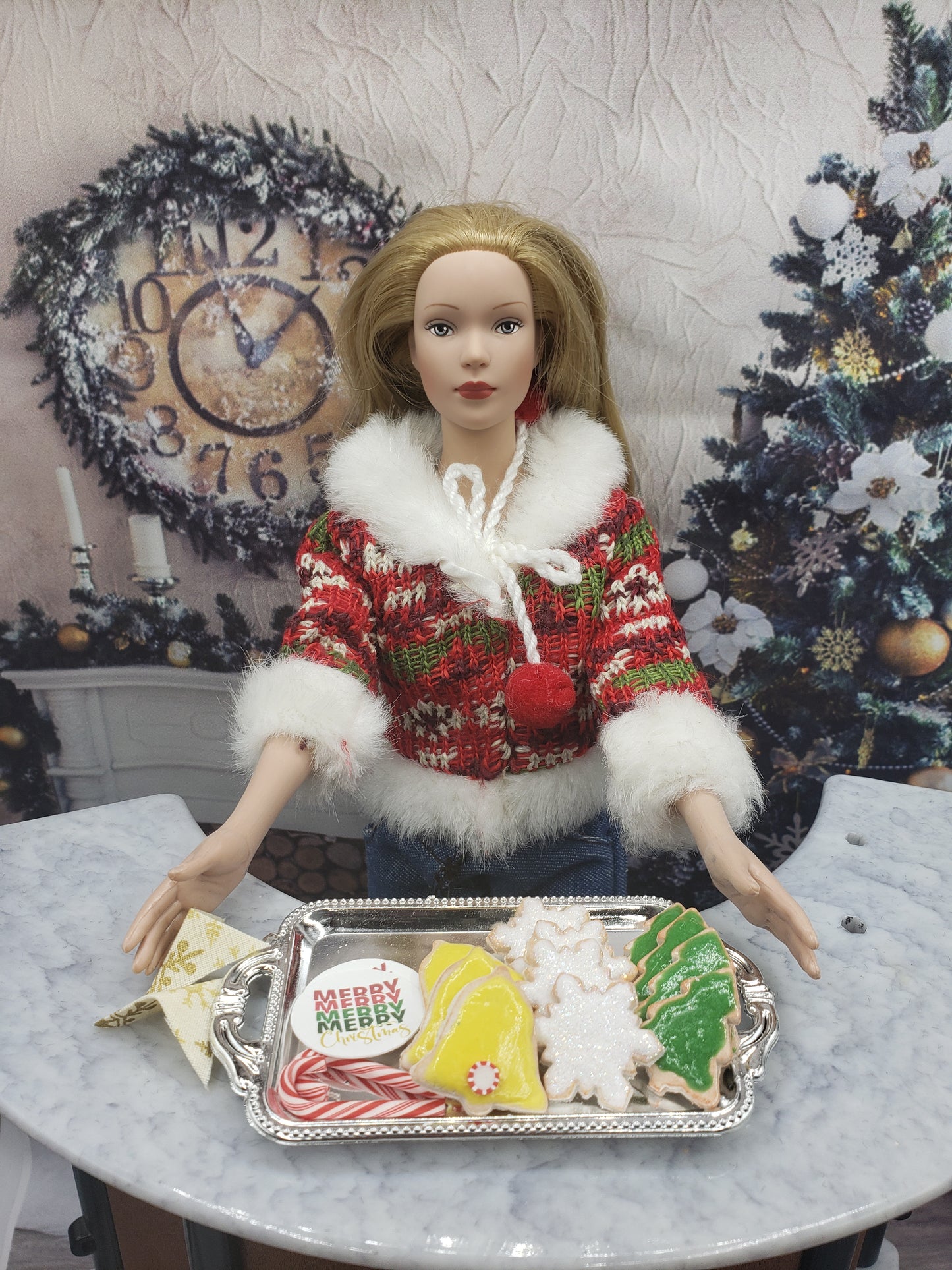 Chef Gina's miniature Christmas cookies for dolls displayed on a silver tray with a doll in festive outfit