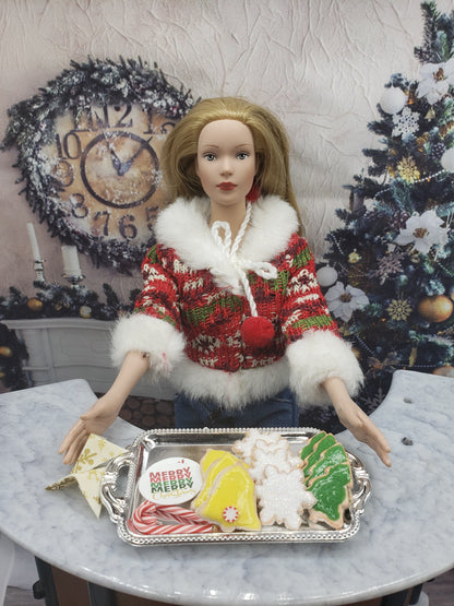 Chef Gina's miniature Christmas cookies for dolls displayed on a silver tray with a doll in festive outfit