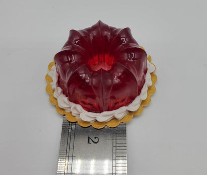 Chef Ginas miniature cranberry jello dessert shaped like a small red gelatin mold on a gold base
