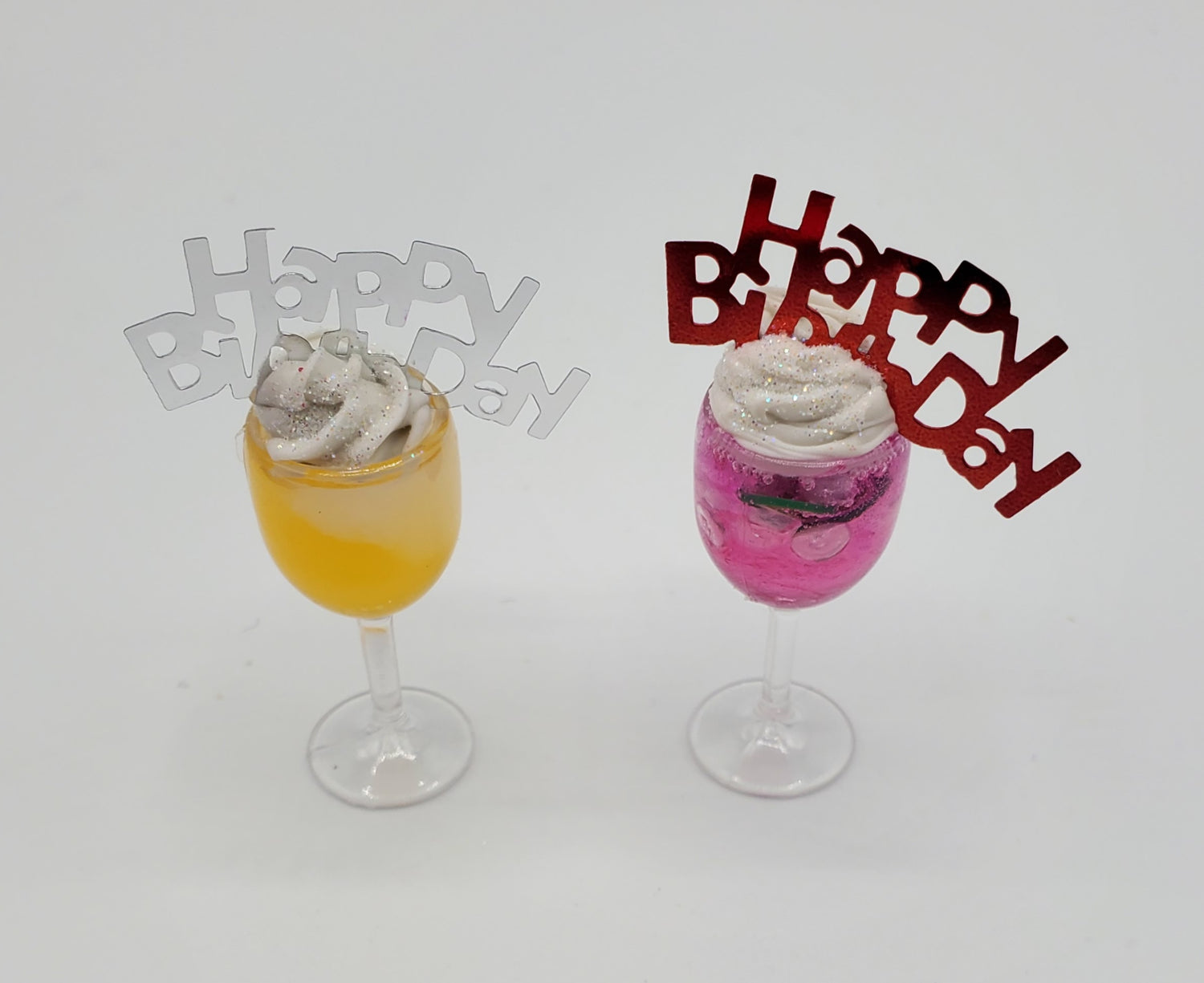 Chef Gina's® Miniature happy birthday cocktail set with yellow and pink drinks topped with whipped cream and happy birthday picks