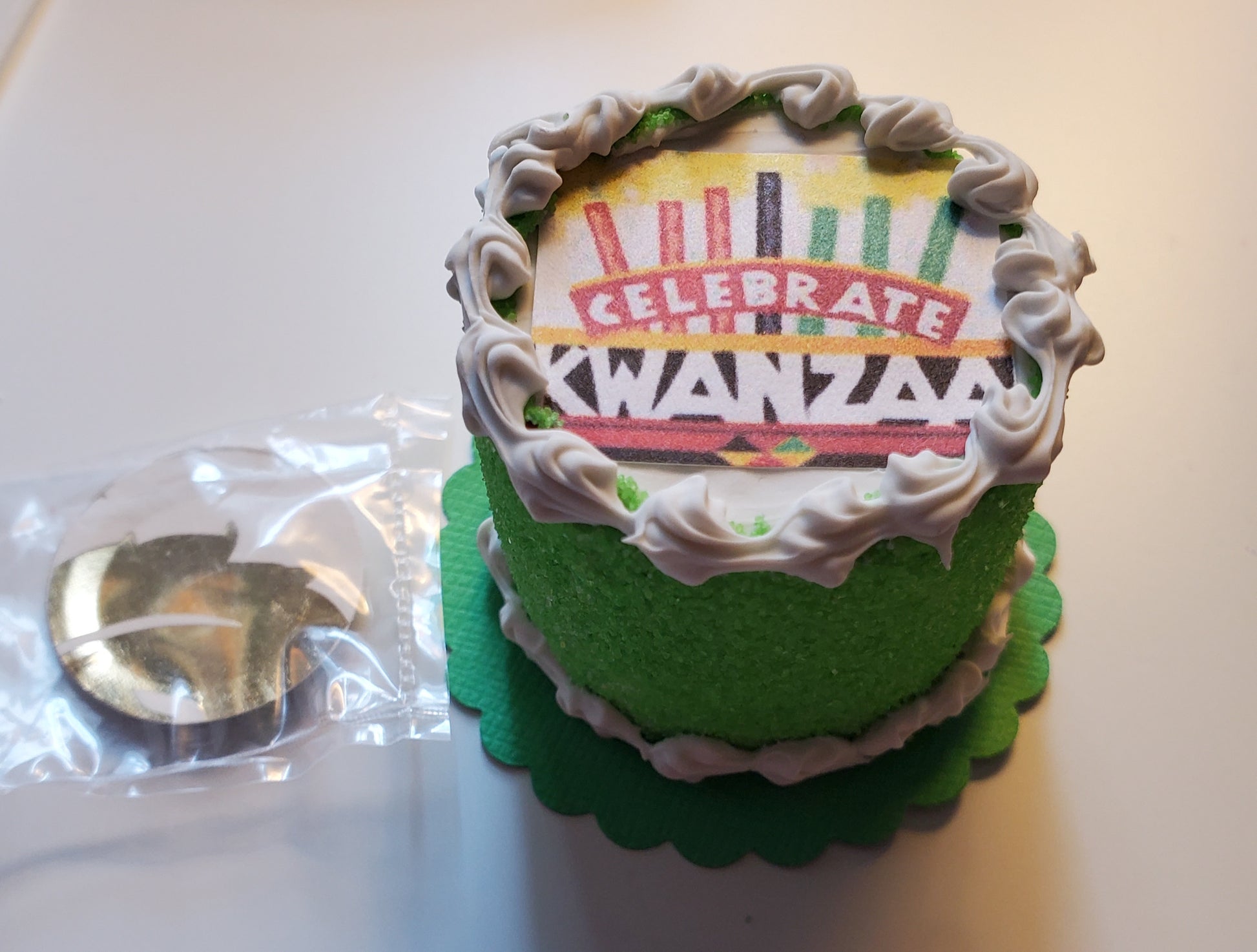 Chef Gina's miniature Kwanzaa cake for dolls with green frosting and Kwanzaa celebration design