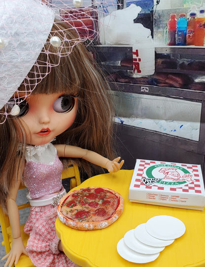 Fashion doll with Chef Gina's miniature pizza Fashion doll food set on yellow table with pizza box and plates