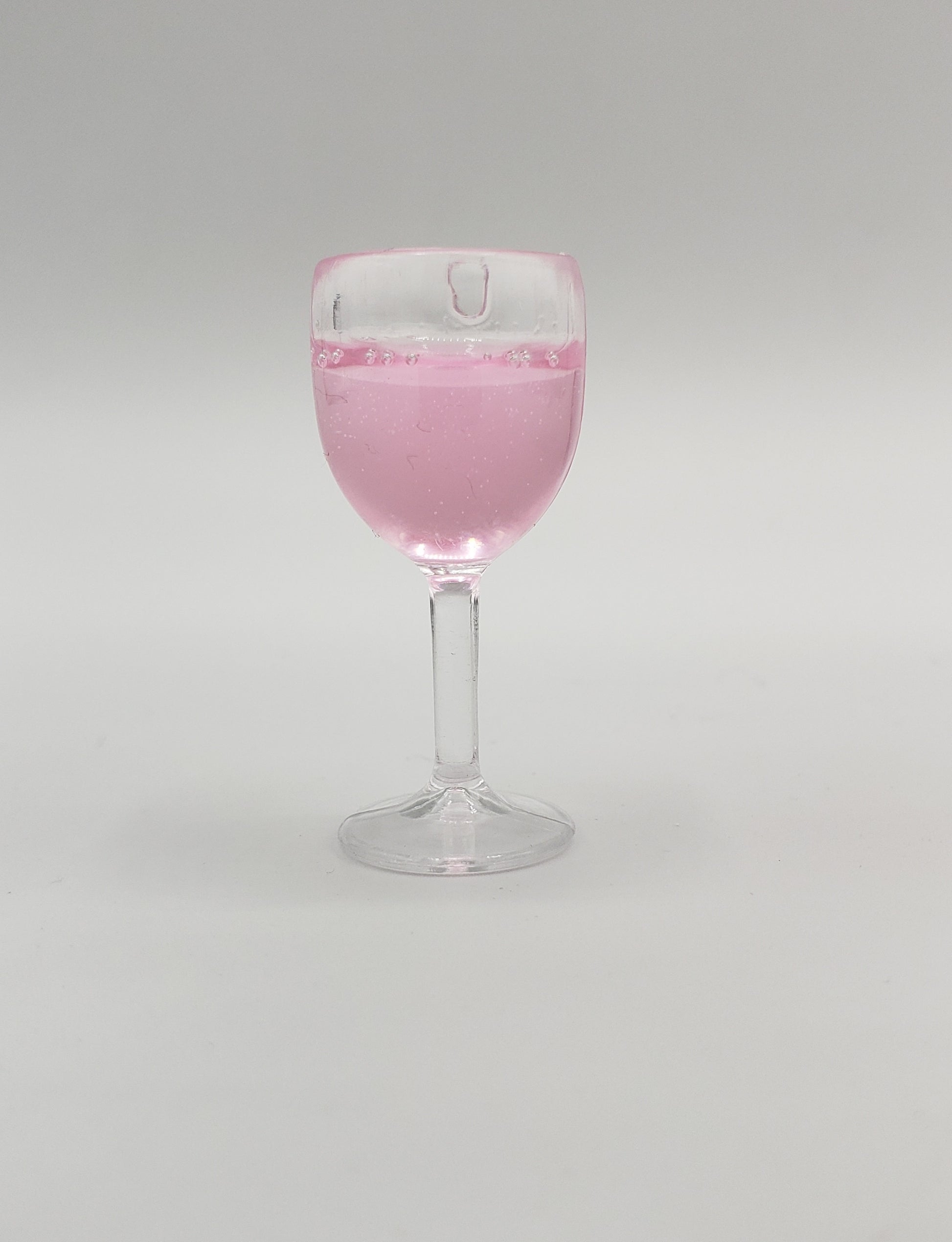 Chef Gina's miniature rose wine for fashion dolls in clear glass with pink liquid inside