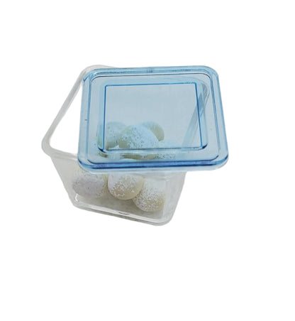 Chef Gina's® miniature rum balls for dolls in a clear container with a blue lid