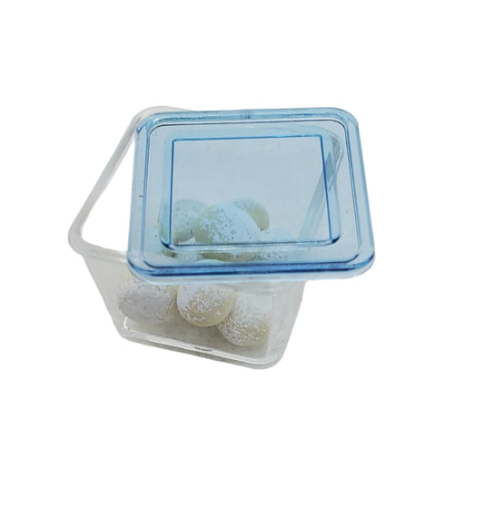 Chef Gina's® miniature rum balls for dolls in a clear container with a blue lid