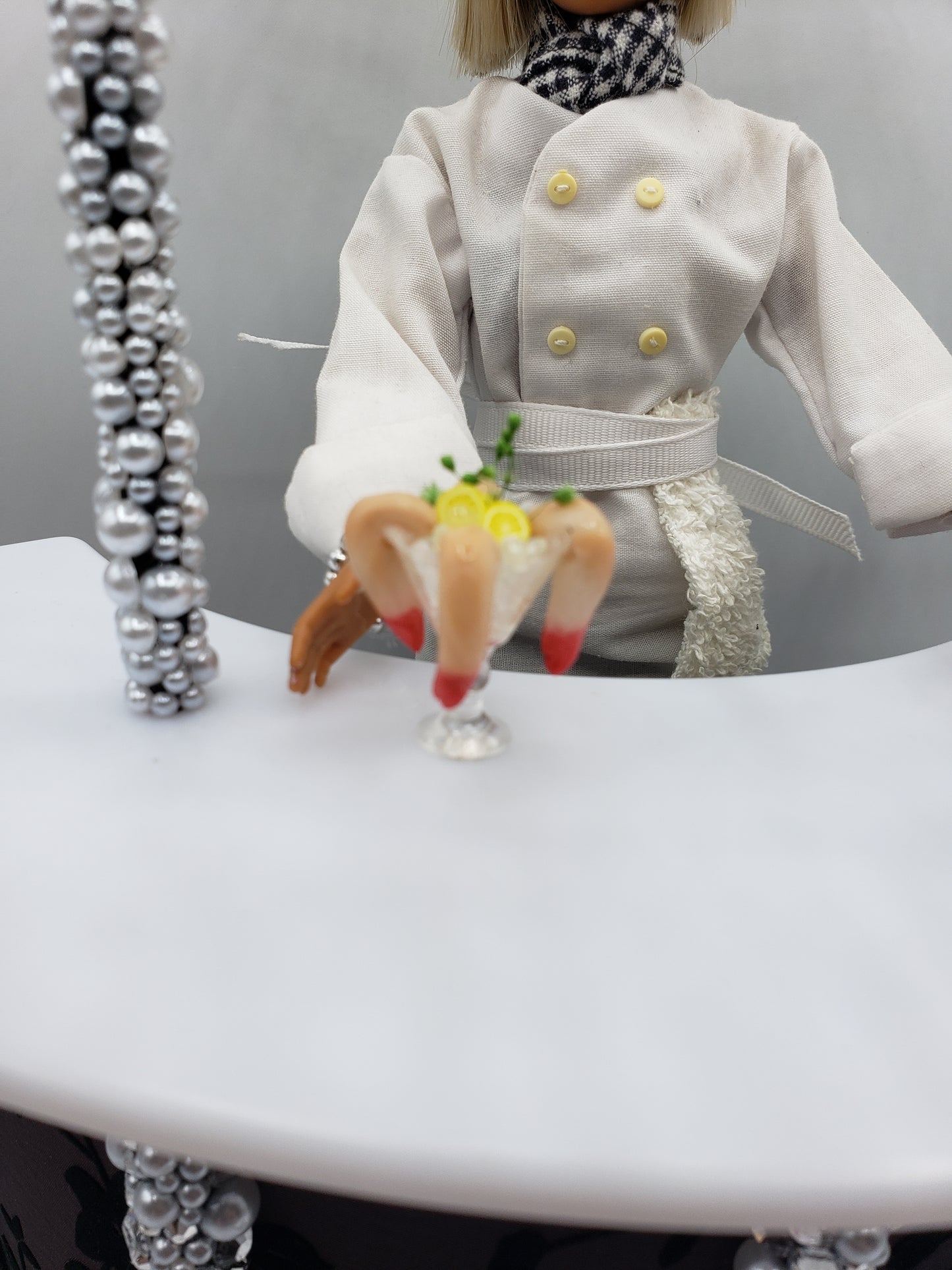 Miniature shrimp cocktail served in a glass held by a doll dressed as a chef from Chef Gina's mini food collection
