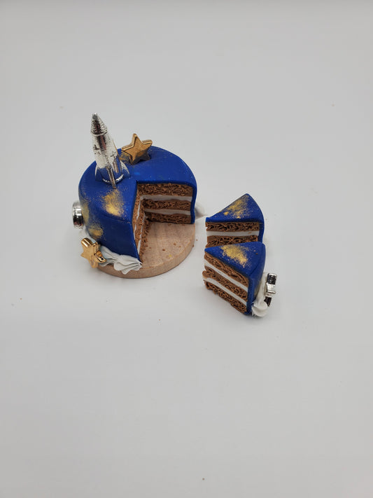 Chef Gina's miniature space cake for dolls with blue frosting and rocket decoration