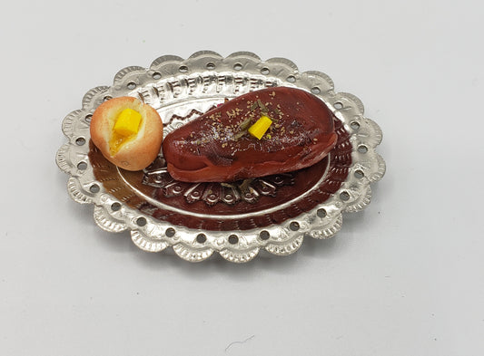 Chef Gina's miniature steak dinner set featuring a tiny steak with sauce and dinner roll on silver plate
