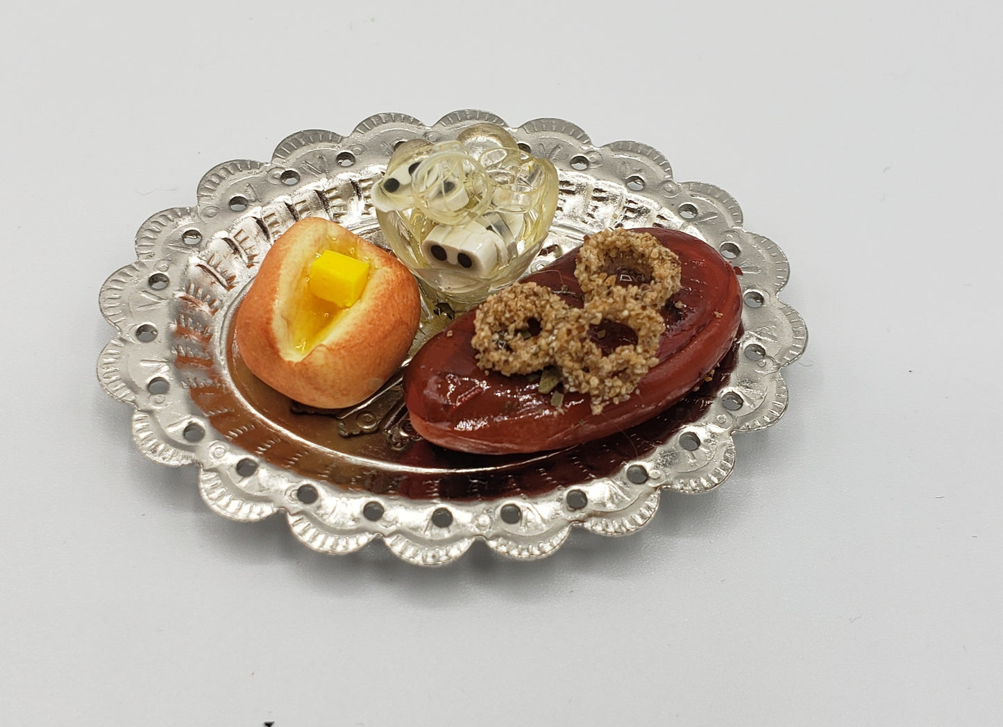 Chef Gina's miniature steak dinner set with steak, onion rings, buttered roll, and salad on a silver platter