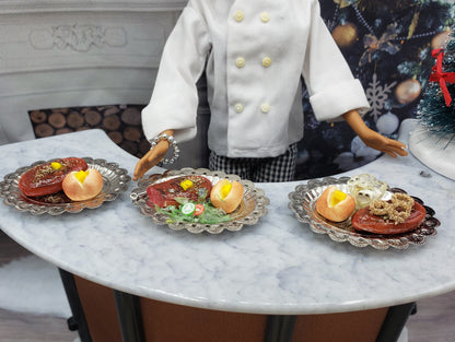 Chef Gina's miniature steak dinner set with steak, bread rolls, and sides on decorative plates