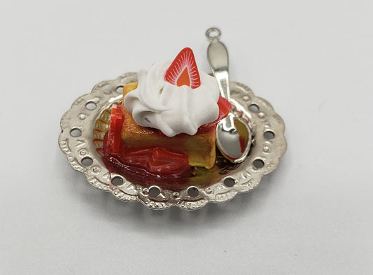 Chef Gina's miniature strawberry shortcake with whipped cream and strawberry slice served on decorative silver plate